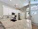 Modern kitchen with white cabinets, stainless steel appliances, granite counters, and an island with a sink at 10105 Dean Point Pl, Orlando, FL 32825