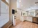 A modern kitchen with wood flooring includes a stylish water cooler, leading into a well-lit living space at 10105 Dean Point Pl, Orlando, FL 32825