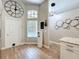 The kitchen with wood flooring boasts a decorative wall clock, white cabinets, and granite countertops for stylish charm at 10105 Dean Point Pl, Orlando, FL 32825