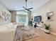 Bright living room with vaulted ceiling, large windows, a modern ceiling fan, and a comfortable white couch at 10105 Dean Point Pl, Orlando, FL 32825