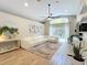 Inviting living room with a large white sofa, wood floors, and sliding glass doors to the backyard at 10105 Dean Point Pl, Orlando, FL 32825