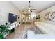Wide angle view of the open-concept living room and kitchen featuring lots of natural light and modern furnishings at 10105 Dean Point Pl, Orlando, FL 32825