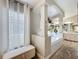 Comfortable main bathroom featuring large bathtub, bright lighting, and modern decorations at 10105 Dean Point Pl, Orlando, FL 32825