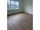 Bedroom featuring wood flooring, natural light, and a neutral color scheme at 1016 Gloryland Ct, Sanford, FL 32771