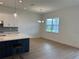 Bright dining area adjacent to the kitchen, featuring wood floors and modern lighting fixtures at 1016 Gloryland Ct, Sanford, FL 32771