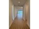 Long hallway with wood flooring leading to living areas at 1016 Gloryland Ct, Sanford, FL 32771