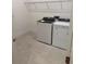 Laundry room with washer, dryer, tiled flooring and overhead shelving at 1016 Gloryland Ct, Sanford, FL 32771