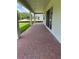 Covered brick patio with views of green lawn and natural backdrop at 1059 Gloryland Ct, Sanford, FL 32771