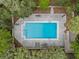 Aerial shot showcases a luxurious pool with ample lounge space, set amongst serene landscaping and privacy fencing at 111 Crown Oaks Way # 101, Longwood, FL 32779