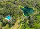 Aerial view of property including pool, lake, and lush green landscaping at 111 Crown Oaks Way # 101, Longwood, FL 32779