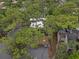 An aerial view shows the property nestled among lush green trees, offering privacy and a natural setting at 111 Crown Oaks Way # 101, Longwood, FL 32779
