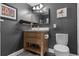 Stylish bathroom featuring a wooden vanity, modern fixtures, and dark, stylish wall paint at 111 Crown Oaks Way # 101, Longwood, FL 32779