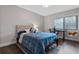 Comfortable bedroom with a desk, neutral tones, and modern decor, perfect for relaxation and work at 111 Crown Oaks Way # 101, Longwood, FL 32779