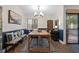 Contemporary dining area featuring a wooden table, stylish seating, and modern decor for sophisticated gatherings at 111 Crown Oaks Way # 101, Longwood, FL 32779