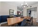 Open-concept dining room featuring a large wooden table with a clear view to living areas at 111 Crown Oaks Way # 101, Longwood, FL 32779