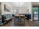 Bright dining area features modern lighting, access to the outside patio, and stylish decor at 111 Crown Oaks Way # 101, Longwood, FL 32779