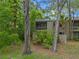 Two-story home with a balcony and surrounded by a forest at 111 Crown Oaks Way # 101, Longwood, FL 32779