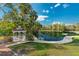 Scenic view of a gazebo next to a pond, adorned by palm trees and landscaped gardens at 111 Crown Oaks Way # 101, Longwood, FL 32779