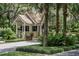 Charming guard house with stone accents, tile roof, and professional landscaping at community entrance at 111 Crown Oaks Way # 101, Longwood, FL 32779