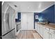 Modern kitchen featuring stainless steel appliances, white cabinetry, and a functional layout for cooking and dining at 111 Crown Oaks Way # 101, Longwood, FL 32779