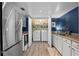 Well-equipped laundry area with modern appliances, next to kitchen appliances for easy access at 111 Crown Oaks Way # 101, Longwood, FL 32779