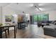 Bright and airy living room with dark wood floors, modern décor, and a sliding door to the outdoors at 111 Crown Oaks Way # 101, Longwood, FL 32779