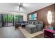 Relaxing living room with exposed brick, modern furniture, and a sliding glass door to a patio at 111 Crown Oaks Way # 101, Longwood, FL 32779
