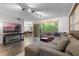 Bright living room area with dark wood floors and sliding glass doors leading to a private patio at 111 Crown Oaks Way # 101, Longwood, FL 32779