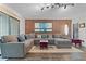Cozy living room with dark wood floors, exposed brick accent wall, and plenty of seating at 111 Crown Oaks Way # 101, Longwood, FL 32779