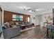 Spacious living room with brick accent wall, contemporary furnishings, and stylish decor at 111 Crown Oaks Way # 101, Longwood, FL 32779