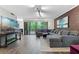 Comfortable living room featuring a brick accent wall, dark wood flooring, and sliding doors to the outdoors at 111 Crown Oaks Way # 101, Longwood, FL 32779