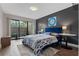 Stylish bedroom with a plush bed, neutral decor, and sliding glass doors leading to a private outdoor area at 111 Crown Oaks Way # 101, Longwood, FL 32779