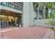 Exterior patio with brick pavers, sliding glass doors, and a view of the surrounding greenery at 111 Crown Oaks Way # 101, Longwood, FL 32779