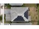 Drone shot of house rooftop featuring new solar panels and a well maintained asphalt shingle roof at 11456 Short Story St, Orlando, FL 32832
