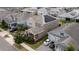 Aerial view of a neighborhood home showcasing solar panels, tidy landscaping, and a well-maintained exterior at 11456 Short Story St, Orlando, FL 32832
