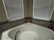 The main bathroom has a garden tub with beautiful tile surround at 11456 Short Story St, Orlando, FL 32832