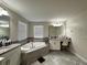 This bathroom features a large tub, granite counters, and tile flooring at 11456 Short Story St, Orlando, FL 32832