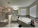 This bathroom features a large tub, walk-in shower, and granite counters at 11456 Short Story St, Orlando, FL 32832