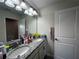 Bright bathroom features a double sink vanity with granite countertop and modern lighting at 11456 Short Story St, Orlando, FL 32832