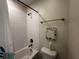 Bathroom featuring white tiles around the shower, bronze fixtures, and a decorative sign on the wall at 11456 Short Story St, Orlando, FL 32832