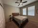 Bedroom with neutral walls, carpet, ceiling fan, and a wood frame bed with side tables at 11456 Short Story St, Orlando, FL 32832