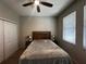 Bedroom with neutral walls, carpet, ceiling fan, and a wood frame bed at 11456 Short Story St, Orlando, FL 32832