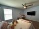 Cozy bedroom with a bed, a TV, a desk, and a ceiling fan creates an inviting space at 11456 Short Story St, Orlando, FL 32832