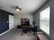 Bedroom featuring neutral walls, ceiling fan, and a cozy nook with an office and seating area at 11456 Short Story St, Orlando, FL 32832