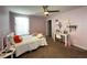 This is a pink bedroom with a ceiling fan and a window with natural light at 11456 Short Story St, Orlando, FL 32832