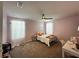 This is a cozy bedroom with plush carpeting and natural light at 11456 Short Story St, Orlando, FL 32832