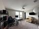 Spacious bedroom with a ceiling fan, two windows, and room for a desk setup or seating area at 11456 Short Story St, Orlando, FL 32832