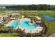 Beautiful aerial view of community pool, splash pad, tennis courts, lounge area, and clubhouse at 11456 Short Story St, Orlando, FL 32832