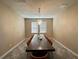 Contemporary dining room featuring a long wood table with seating for eight and a modern chandelier at 11456 Short Story St, Orlando, FL 32832