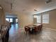 Bright dining room features stylish chandelier over the dining table with seating for six at 11456 Short Story St, Orlando, FL 32832
